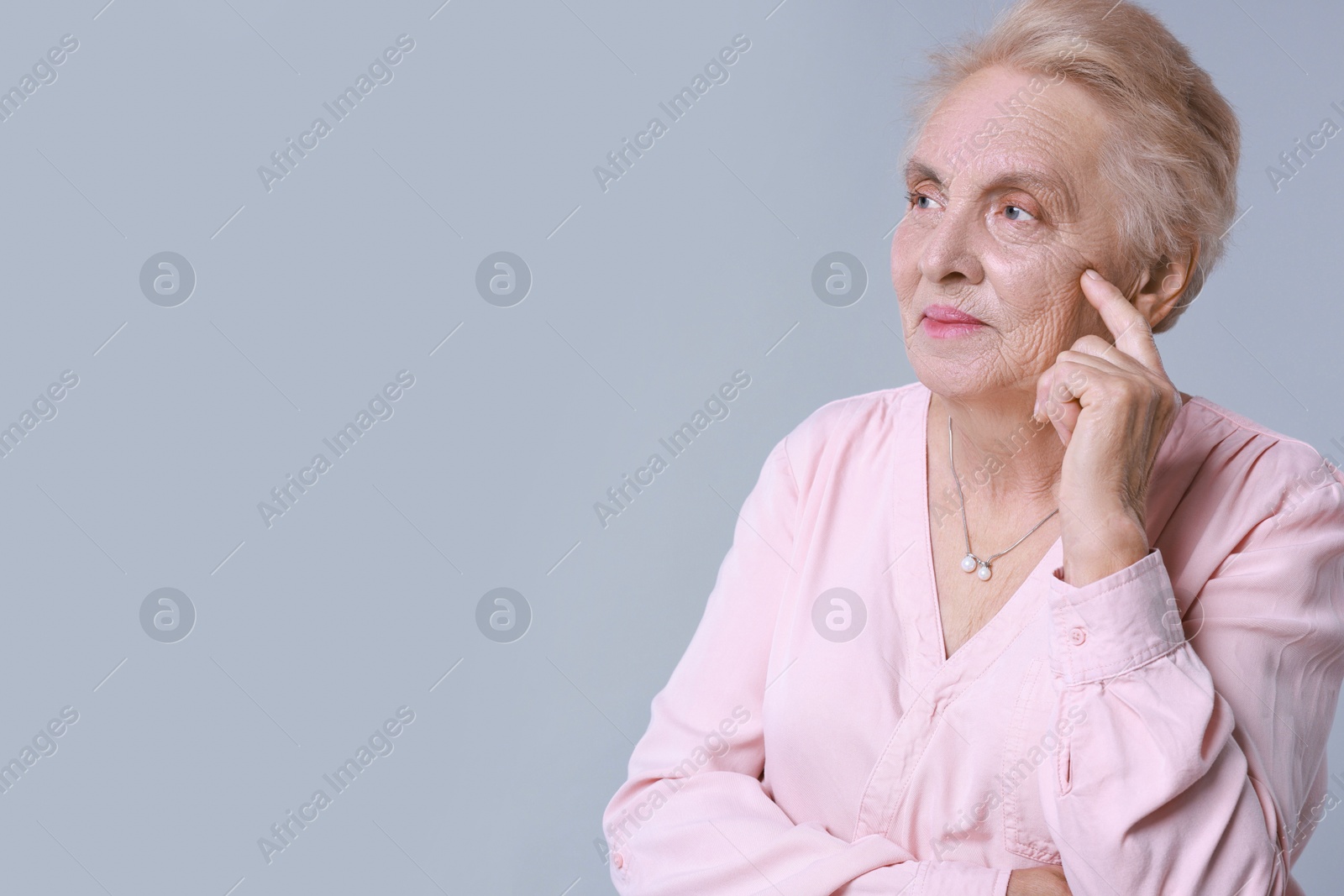 Photo of Portrait of senior woman on light background. Space for text