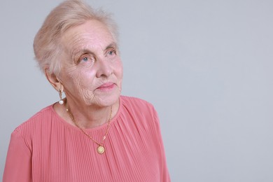 Photo of Portrait of senior woman on light background. Space for text