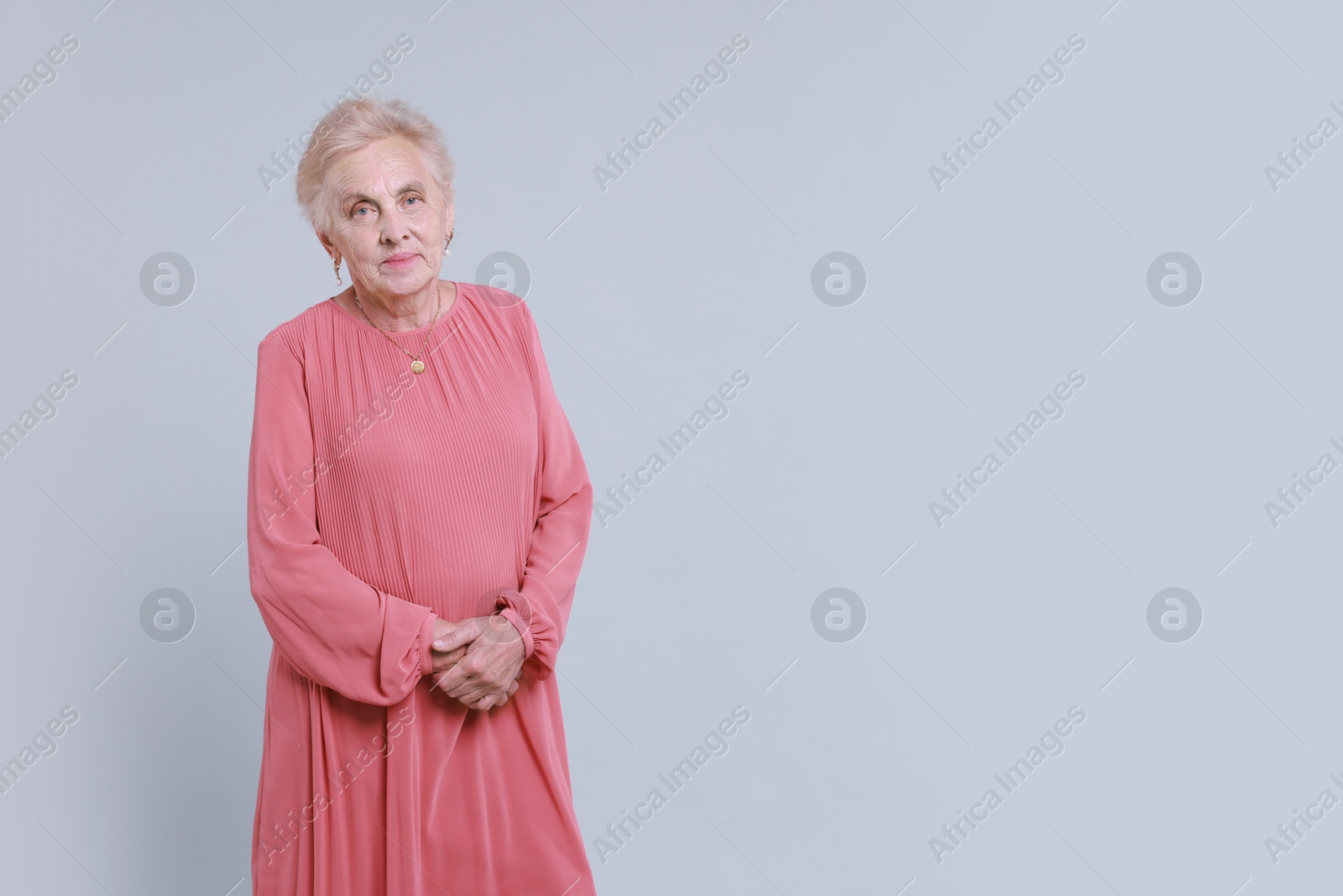 Photo of Portrait of senior woman on light background. Space for text