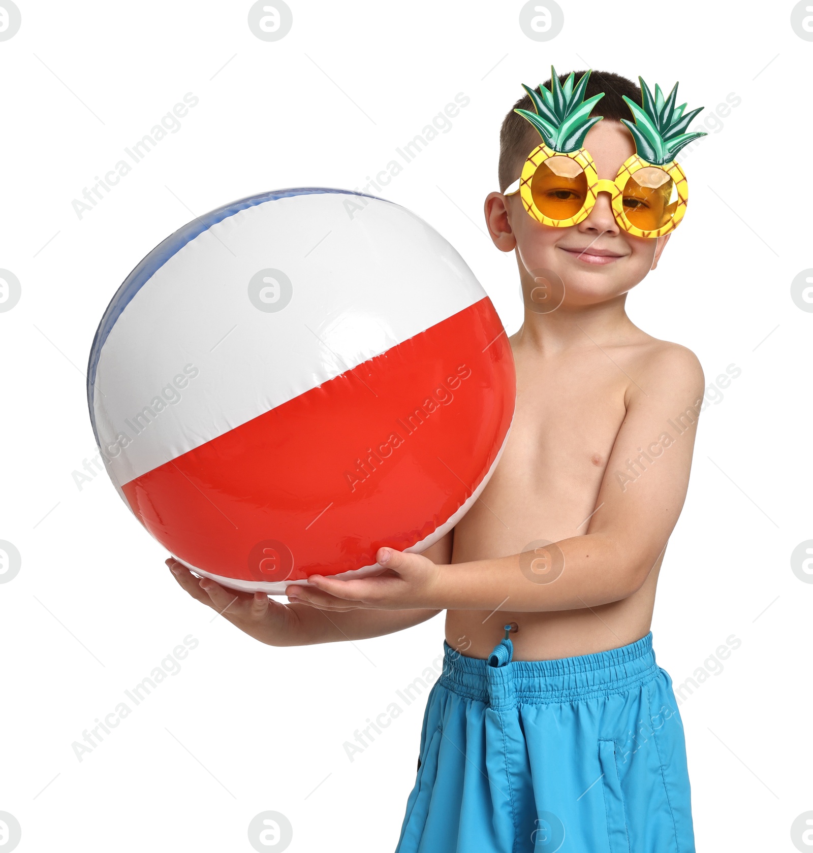 Photo of Cute little boy in beachwear with funny sunglasses and inflatable ball on white background