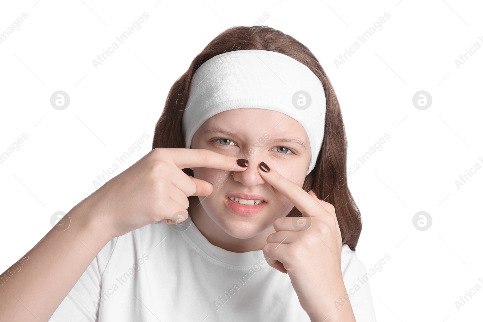 Photo of Teenage girl popping pimple on her face against white background. Acne problem