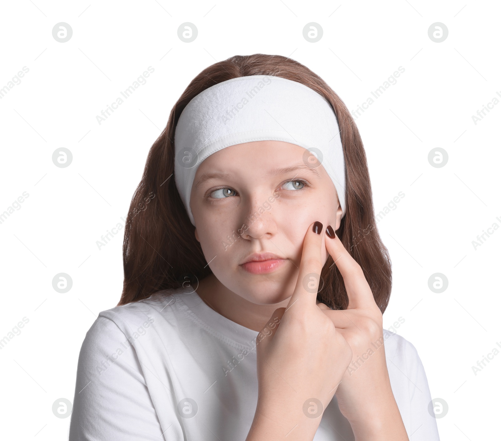 Photo of Teenage girl popping pimple on her face against white background. Acne problem