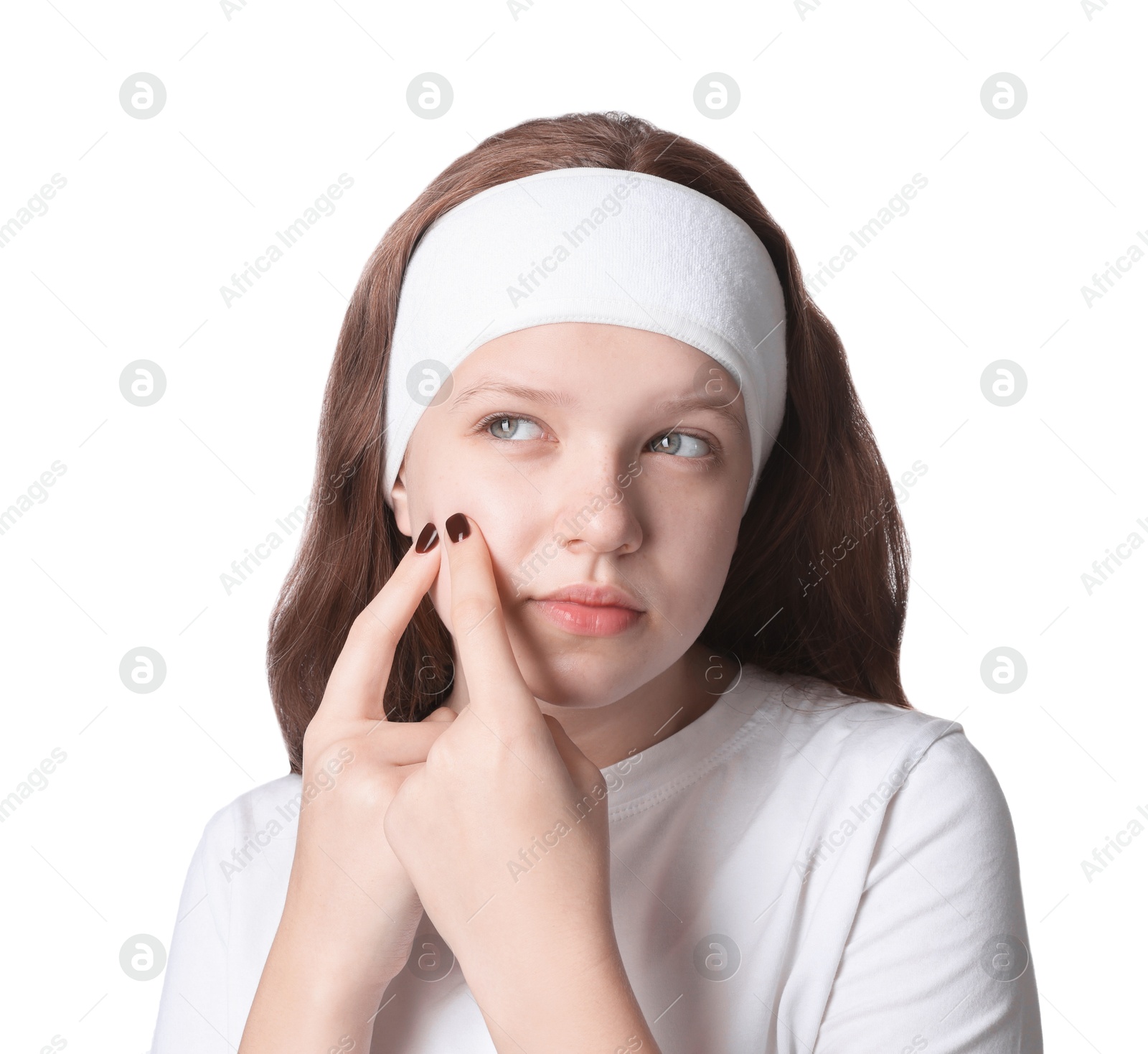 Photo of Teenage girl popping pimple on her face against white background. Acne problem