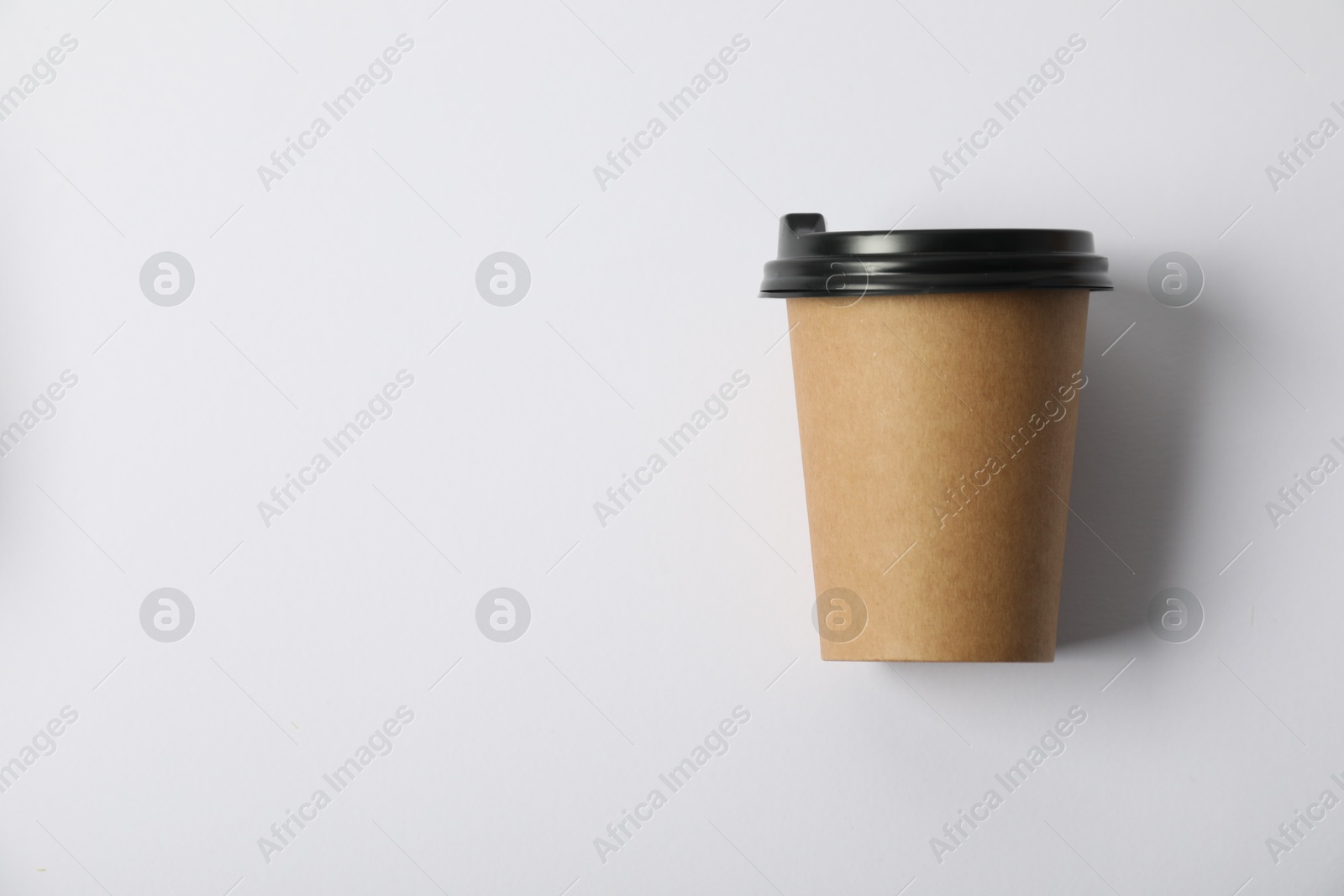 Photo of Paper cup with lid on white background, top view. Mockup for design