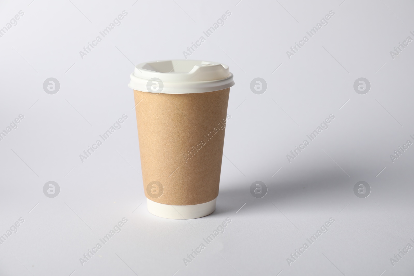 Photo of Paper cup with lid on white background. Mockup for design