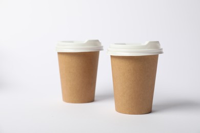 Photo of Paper cups on white background. Mockup for design