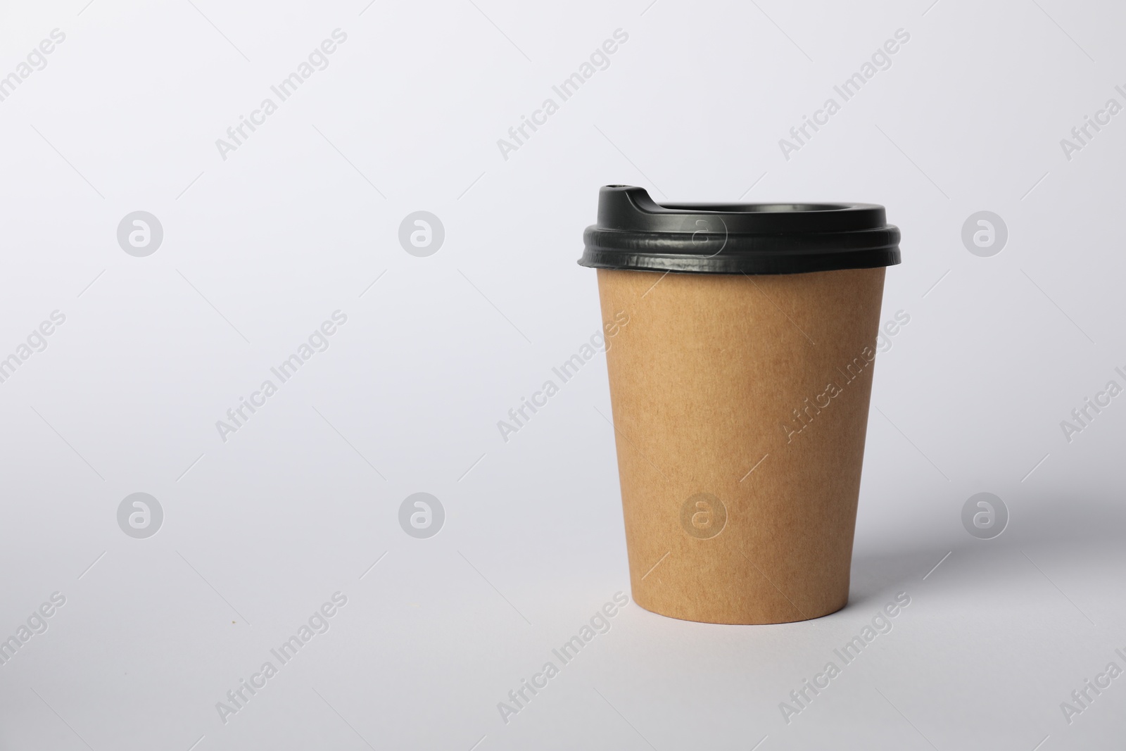 Photo of Paper cup with lid on white background. Mockup for design