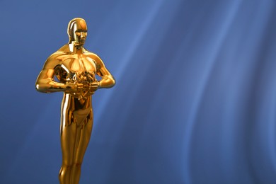 Photo of Golden trophy in shape of human figure on blue background, space for text