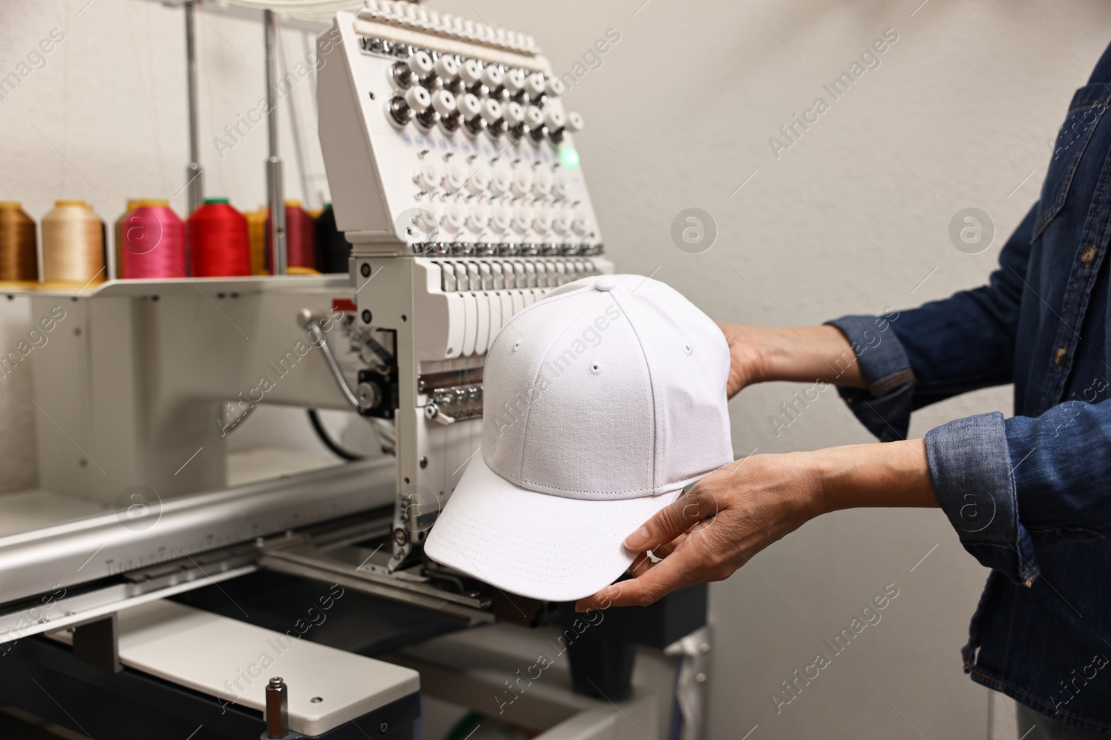 Photo of Woman with blank baseball cap for print indoors, closeup