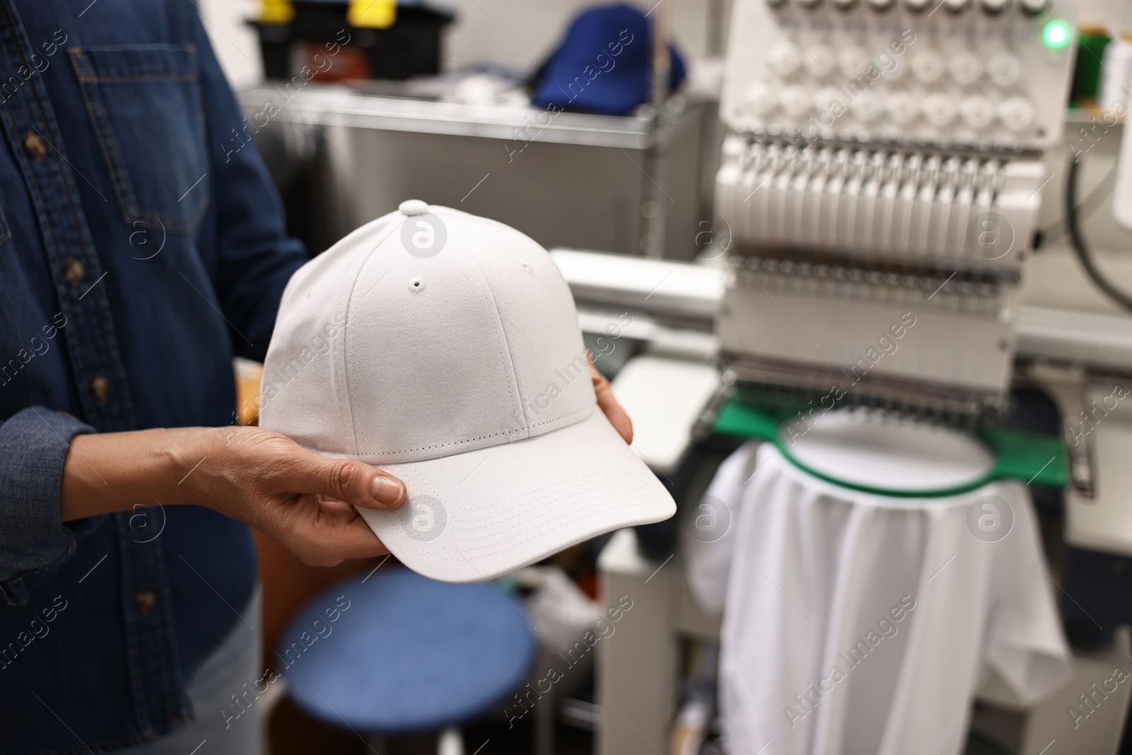 Photo of Woman with blank baseball cap for print indoors, closeup