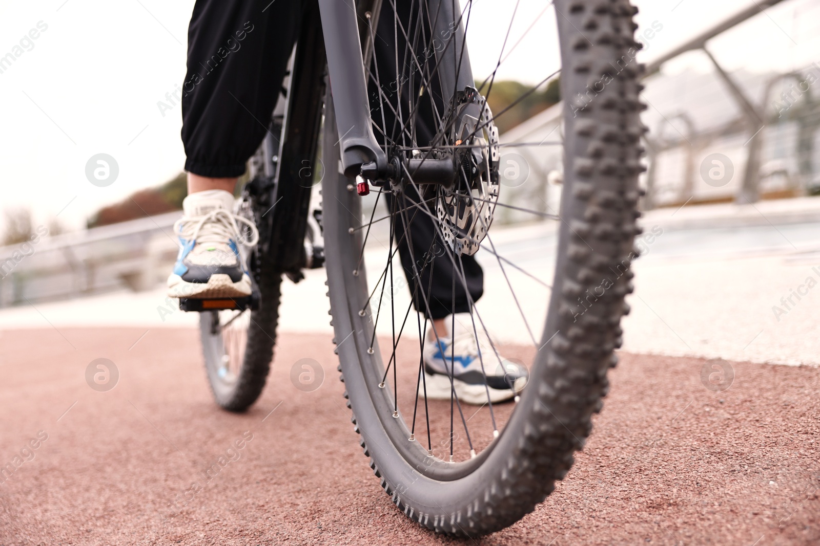 Photo of Woman with bicycle outdoors, closeup. Healthy lifestyle