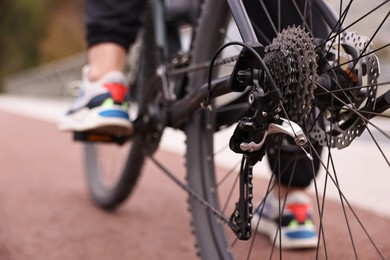 Woman with bicycle outdoors, closeup. Healthy lifestyle