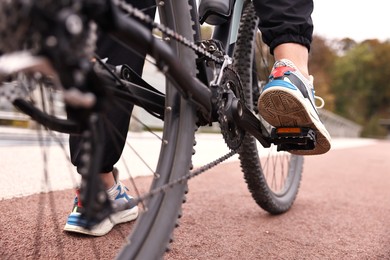 Woman with bicycle outdoors, closeup. Healthy lifestyle