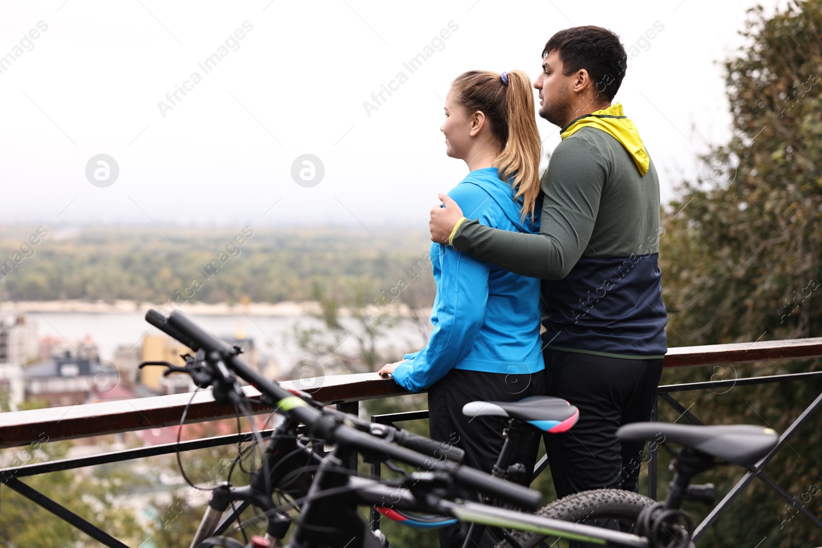 Photo of Beautiful happy couple with bicycles spending time together outdoors