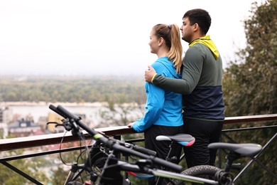 Photo of Beautiful happy couple with bicycles spending time together outdoors