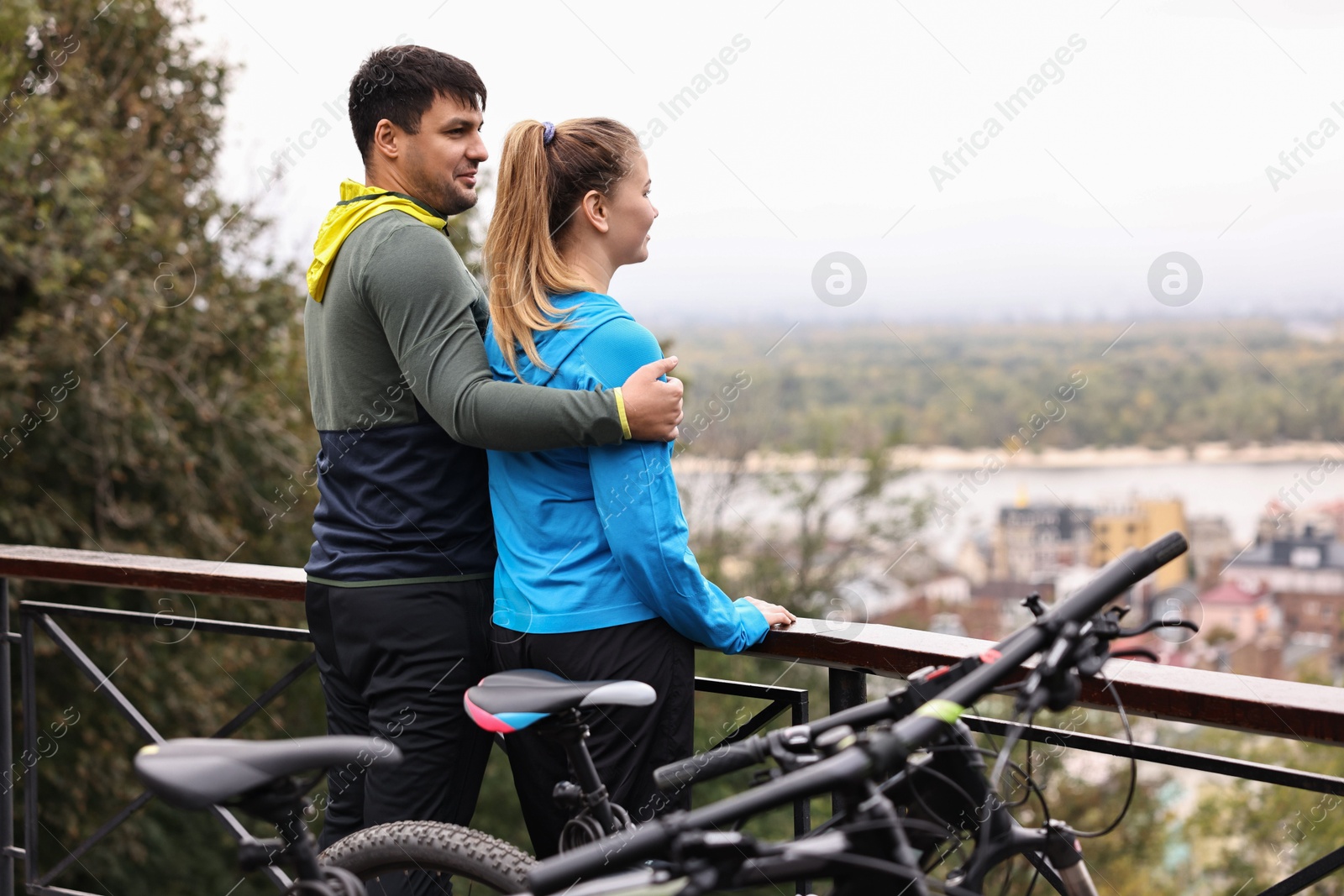 Photo of Beautiful happy couple with bicycles spending time together outdoors