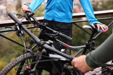 Photo of Couple with bicycles spending time together outdoors, closeup