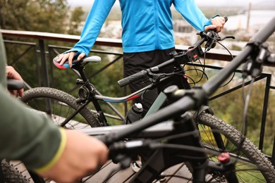 Couple with bicycles spending time together outdoors, closeup