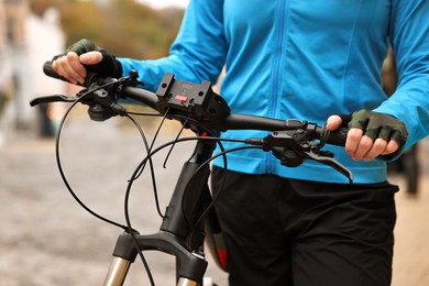 Photo of Woman with bicycle outdoors, closeup. Healthy lifestyle