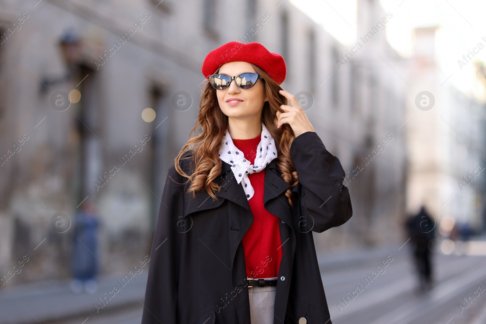 Photo of Charming young woman in stylish outfit on city street. Autumn season