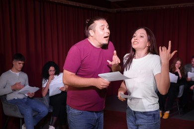 Professional actors rehearsing on stage in theatre