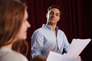 Professional actors rehearsing on stage in theatre