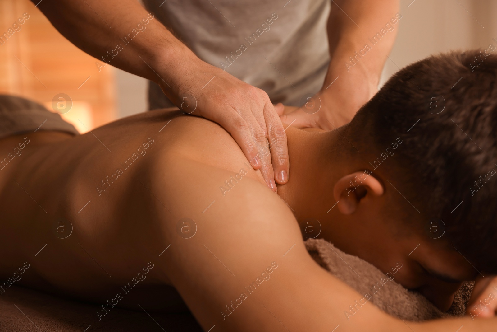 Photo of Massage therapist working with patient in clinic, closeup