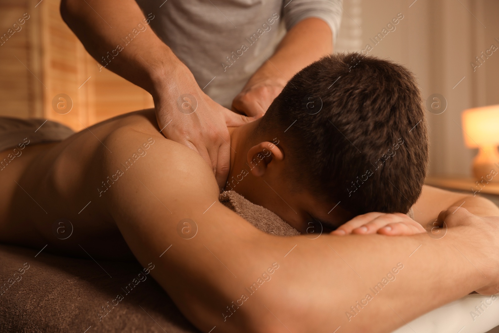 Photo of Massage therapist working with patient in clinic, closeup