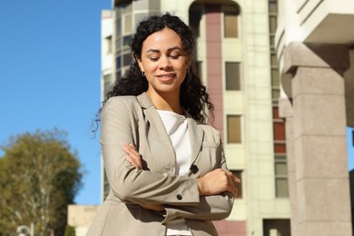 Photo of Portrait of young woman wearing stylish suit outdoors