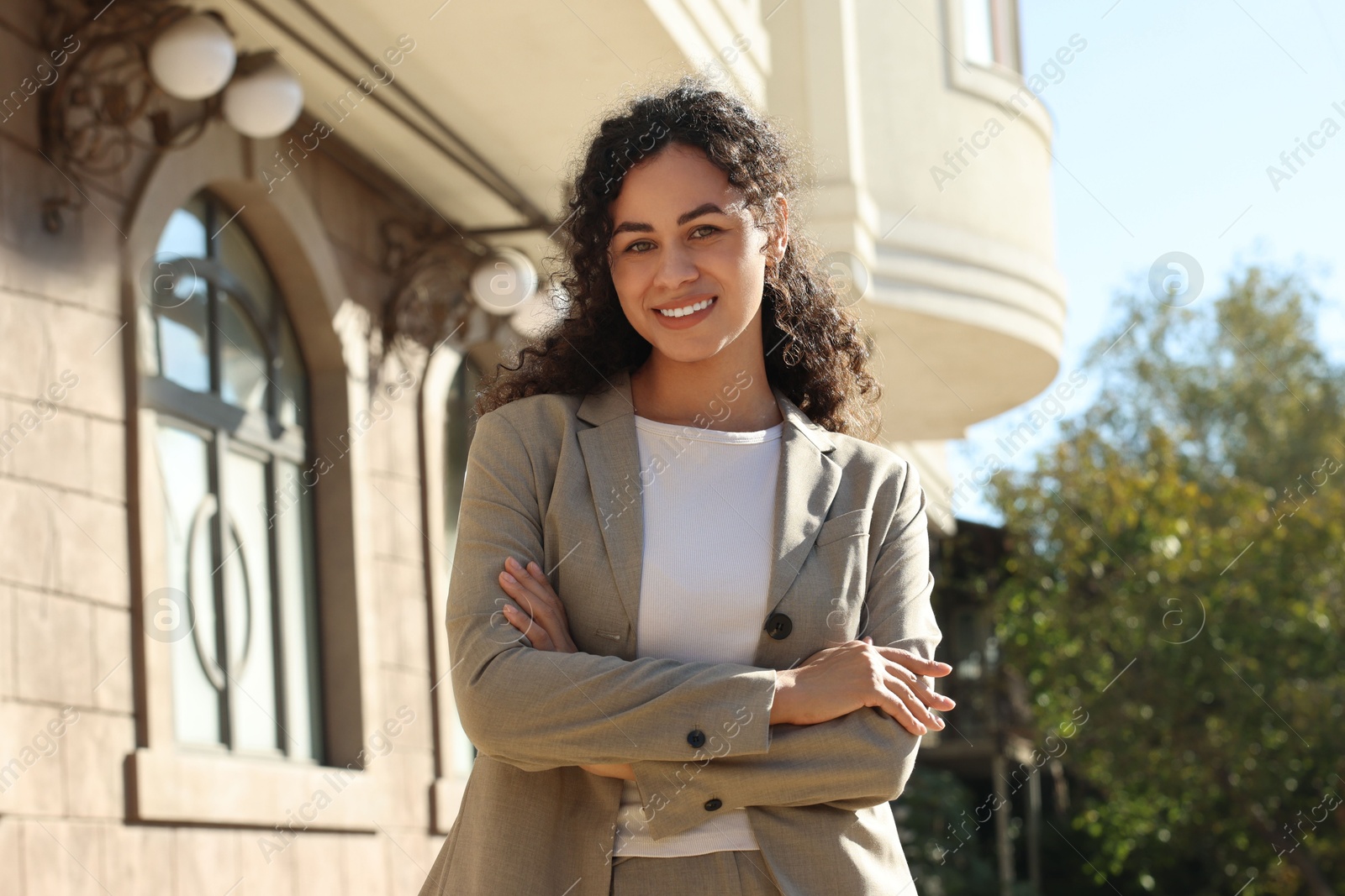 Photo of Portrait of young woman wearing stylish suit outdoors