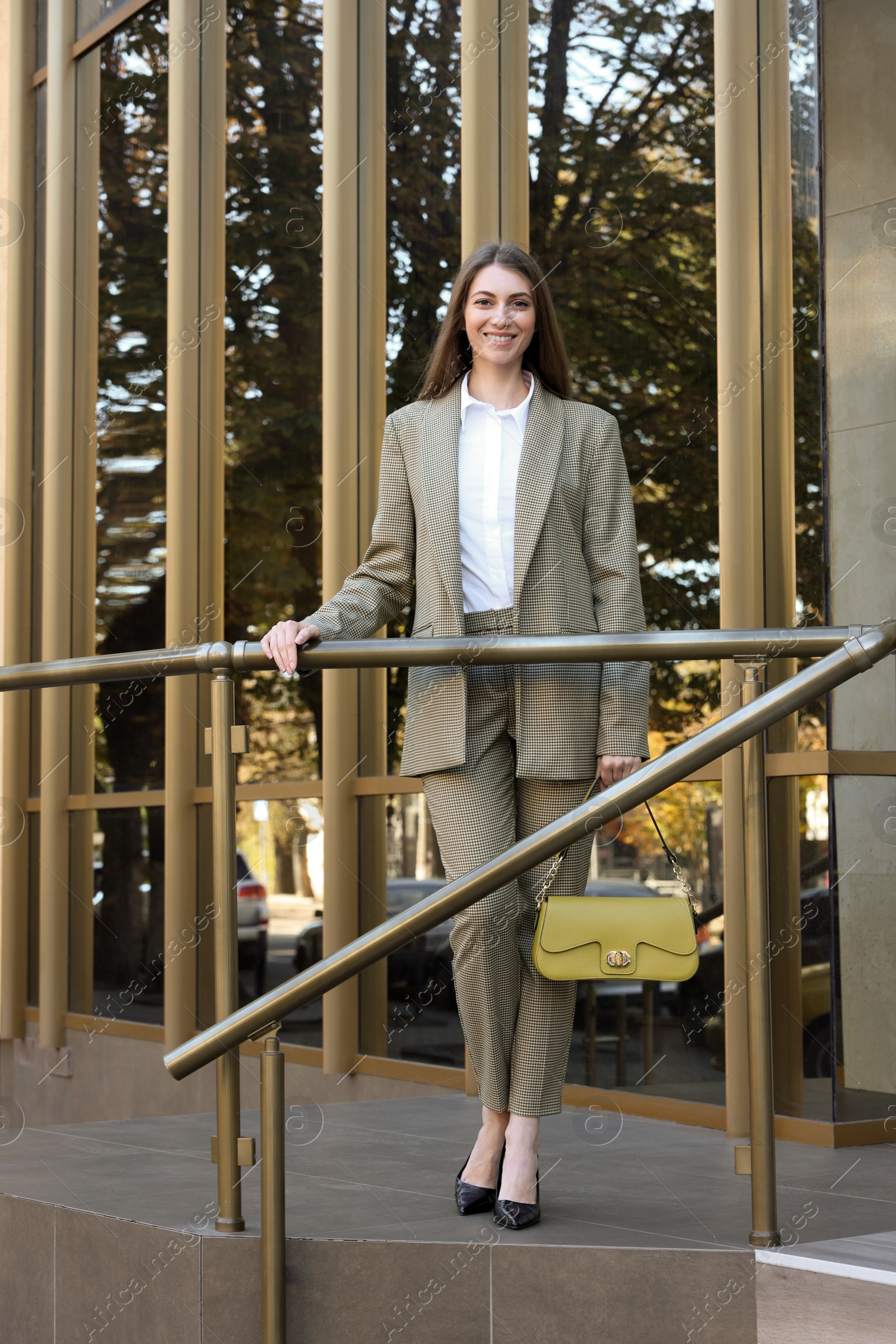 Photo of Portrait of young woman wearing stylish suit outdoors