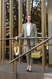 Portrait of young woman wearing stylish suit outdoors