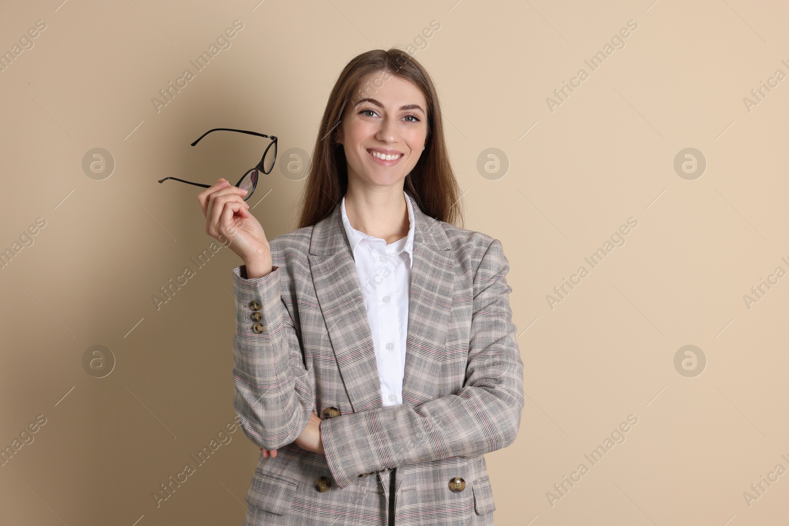 Photo of Portrait of smiling banker on beige background