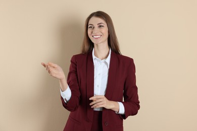 Portrait of smiling banker on beige background