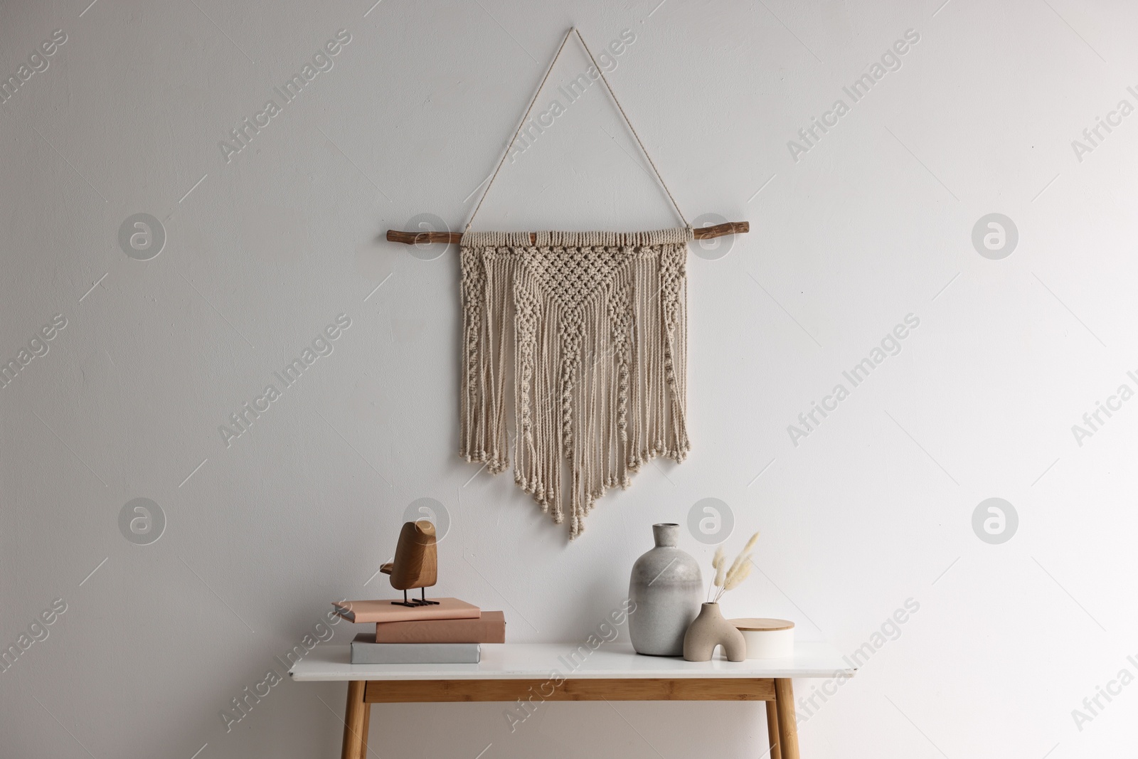 Photo of Stylish console table with decor near white wall indoors