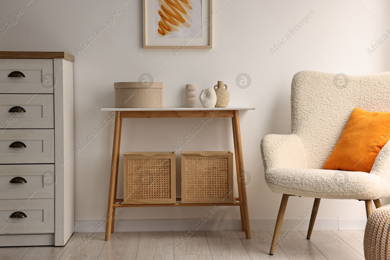 Photo of Stylish room interior with console table near white wall