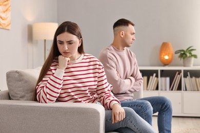 Offended couple ignoring each other at home