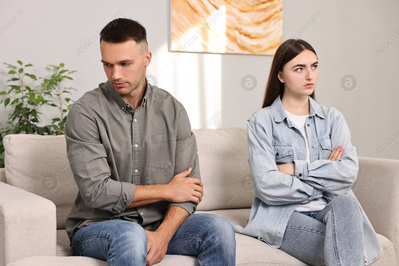 Photo of Offended couple ignoring each other at home