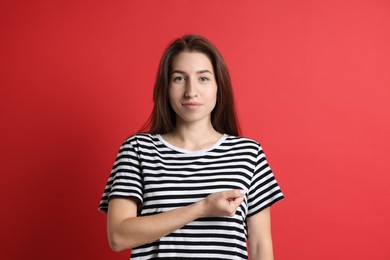 Photo of Woman making promise on red background. Oath gesture