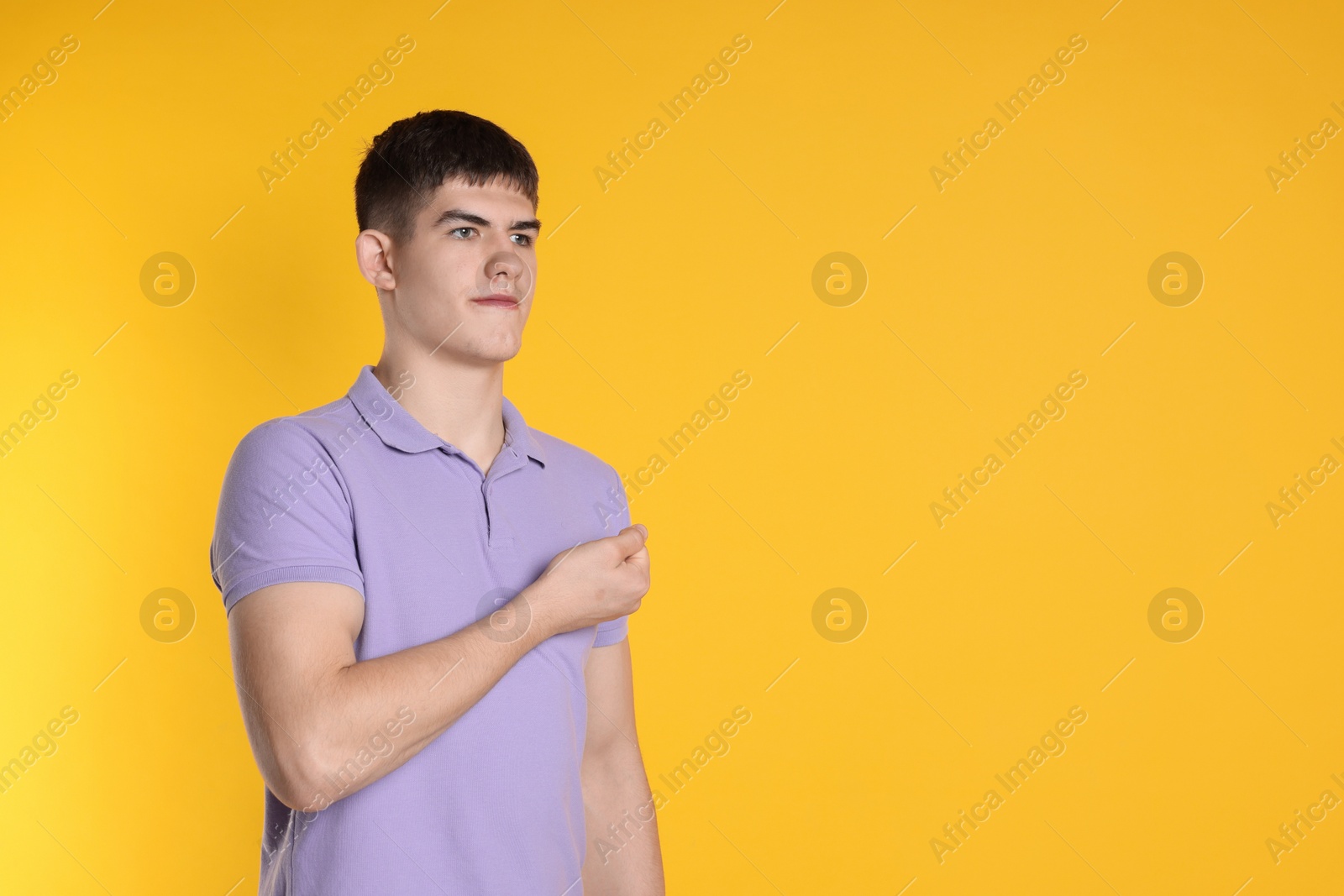 Photo of Man showing oath gesture on orange background. Space for text