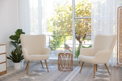 Photo of Stylish living room interior with soft white armchairs