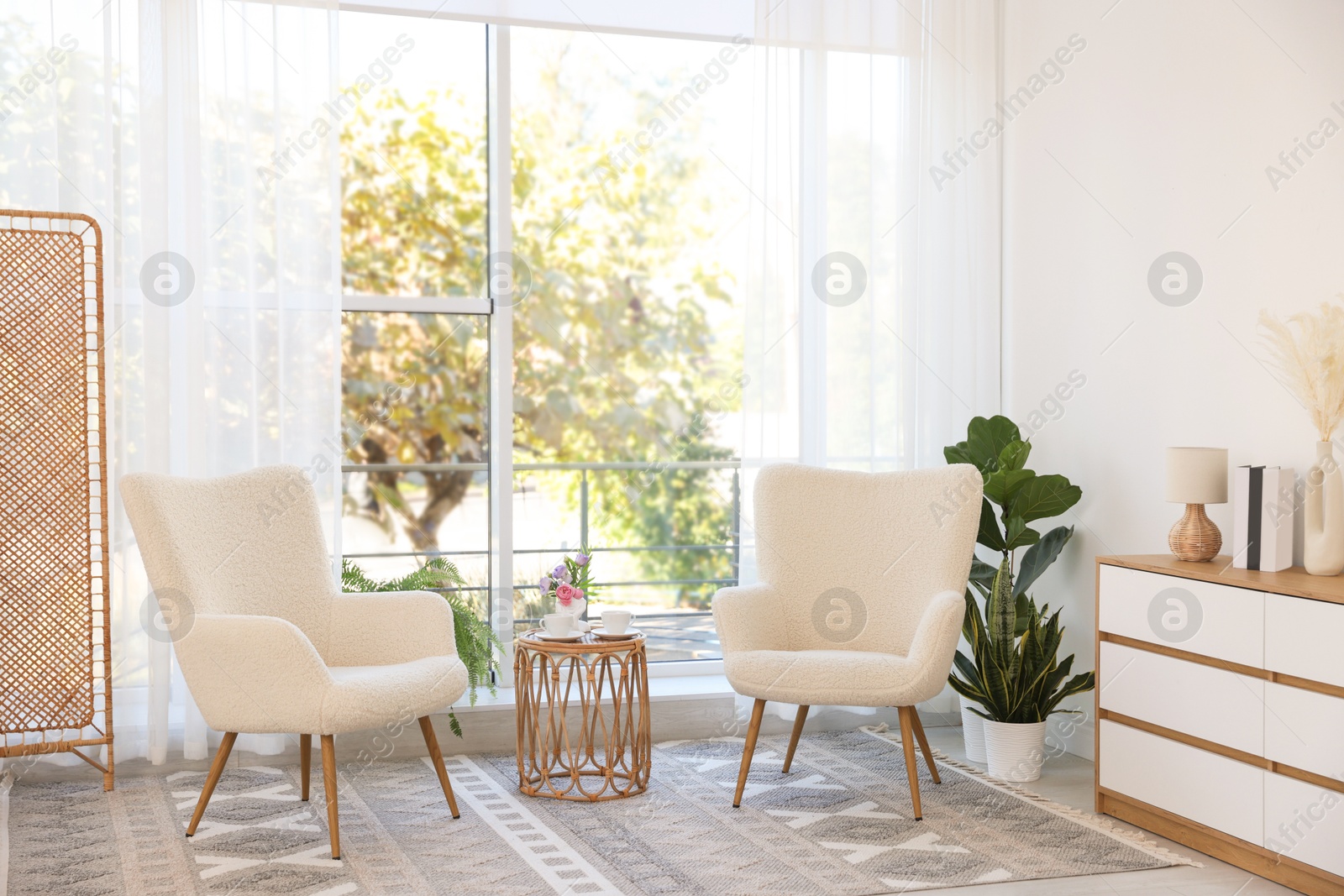 Photo of Stylish living room interior with soft white armchairs