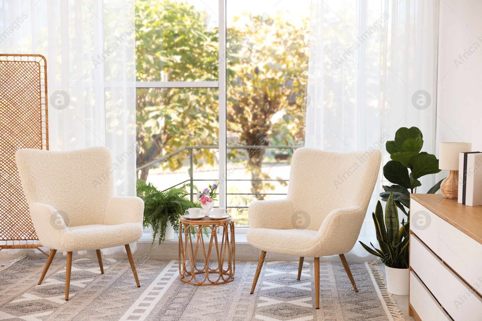 Photo of Stylish living room interior with soft white armchairs