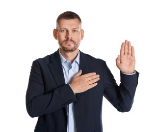 Photo of Man making promise with raised hand on white background. Oath gesture