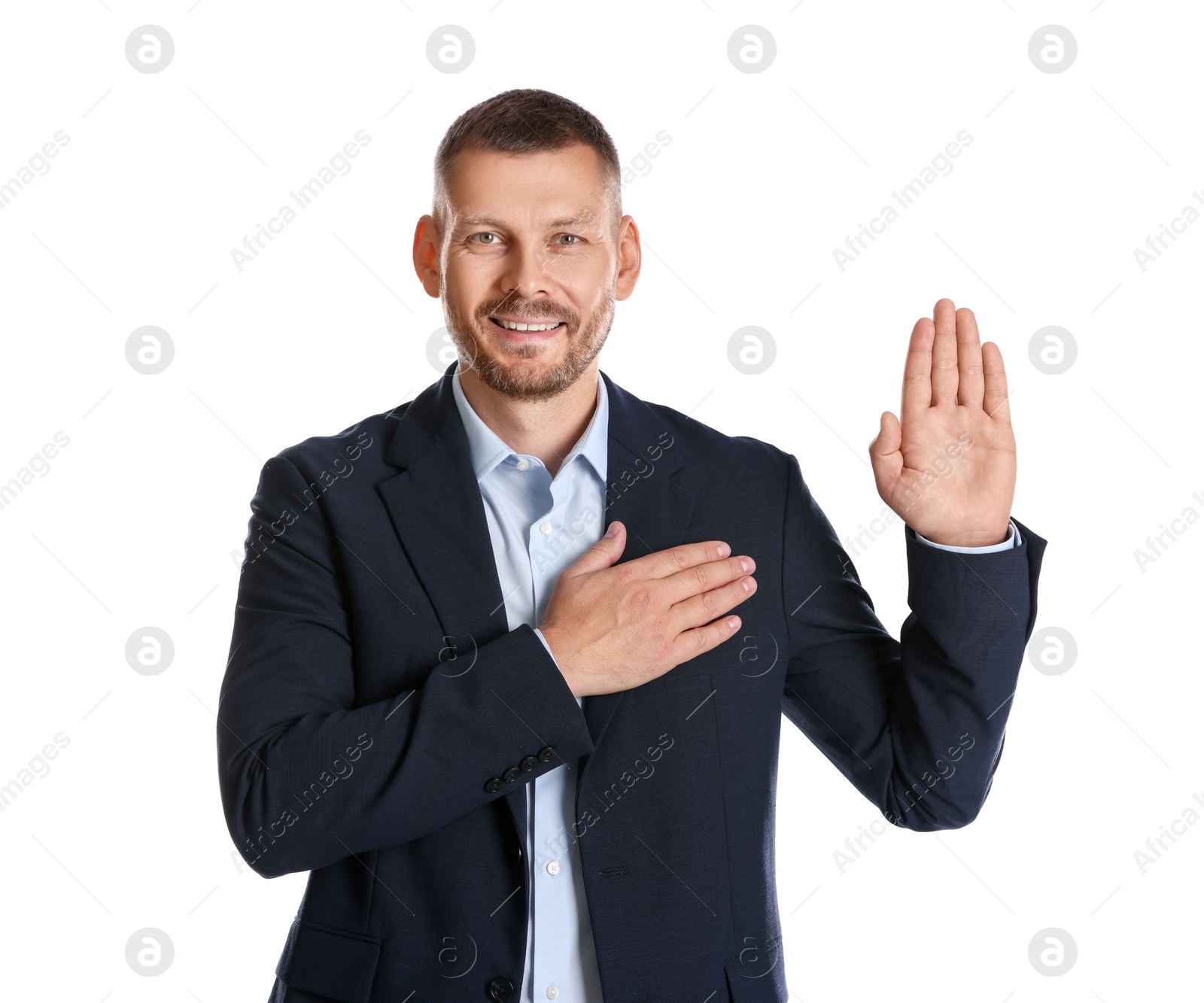 Photo of Man making promise with raised hand on white background. Oath gesture