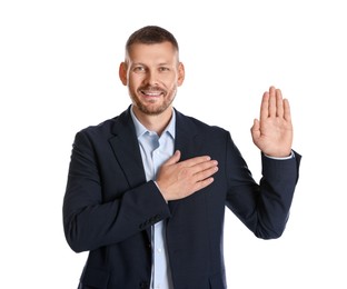 Photo of Man making promise with raised hand on white background. Oath gesture