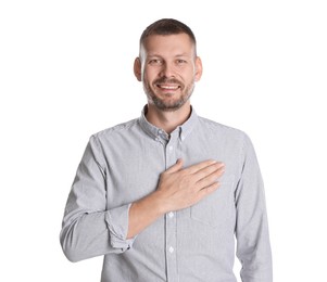 Photo of Man making promise on white background. Oath gesture