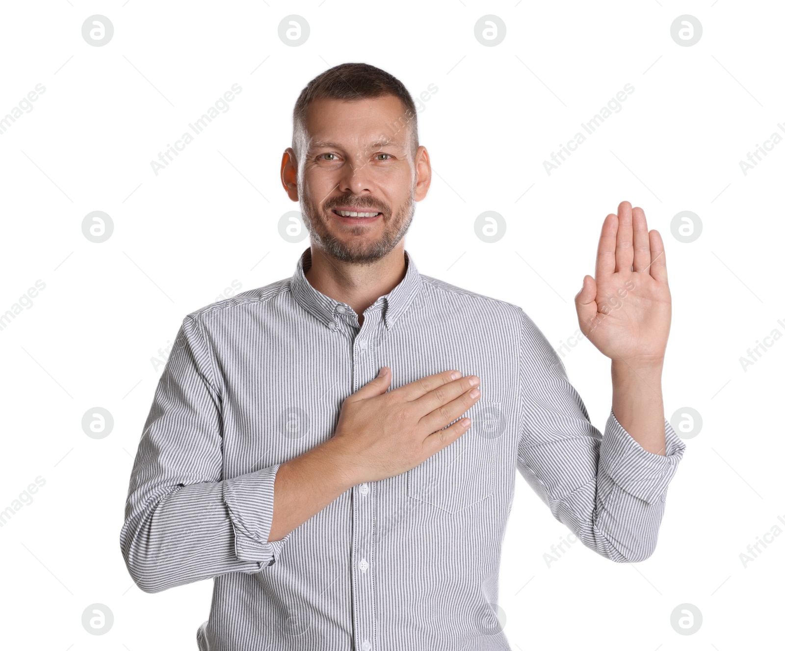 Photo of Man making promise with raised hand on white background. Oath gesture