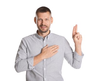 Photo of Man showing oath gesture on white background. Making promise