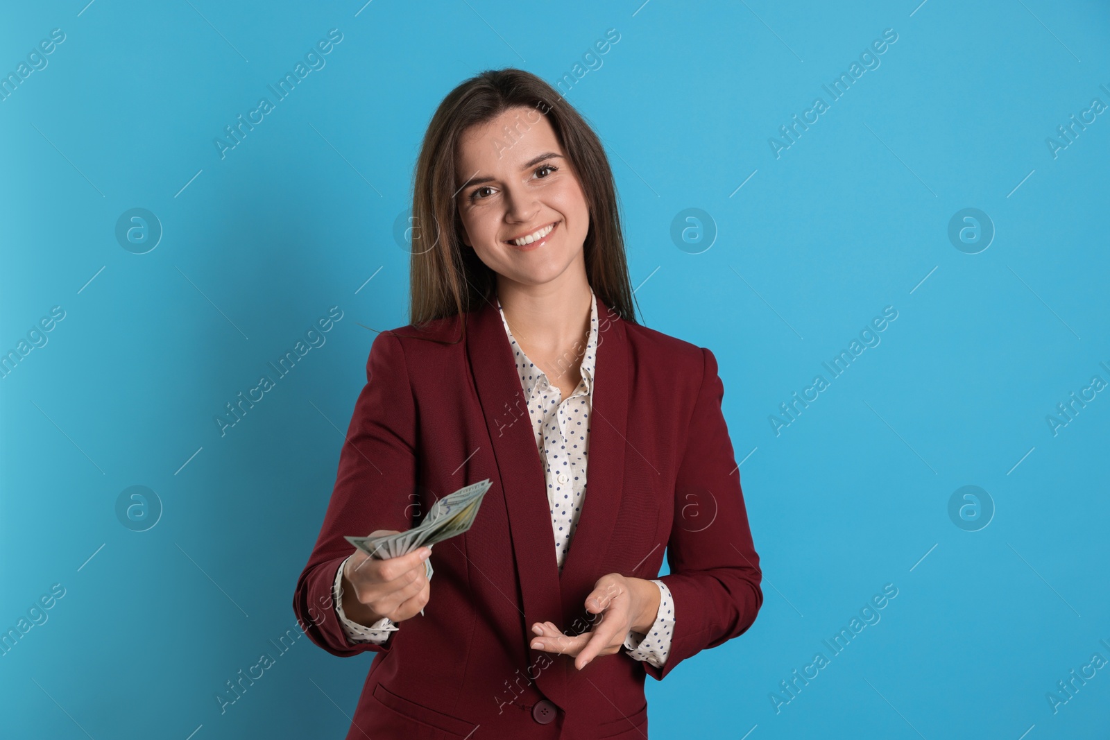 Photo of Banker with dollar banknotes on light blue background